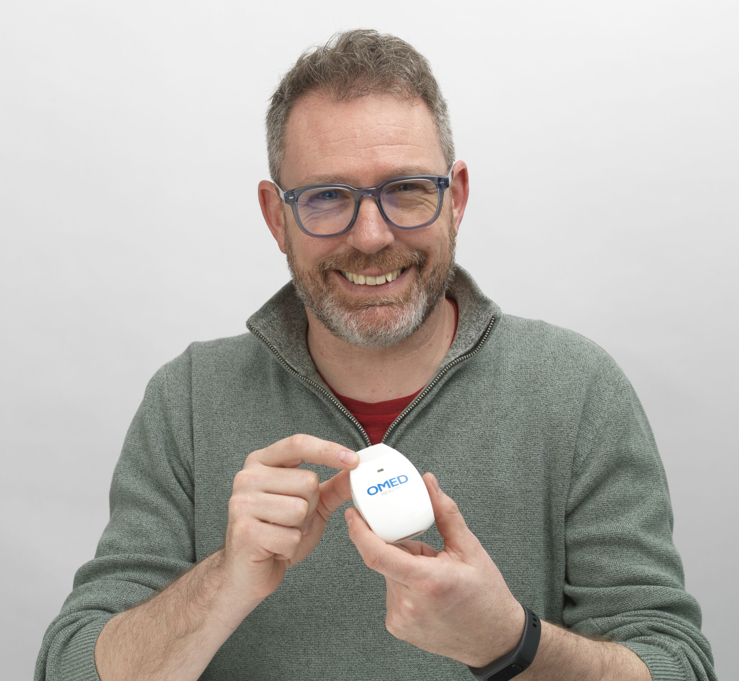 man smiling with omed device near mouth (6)