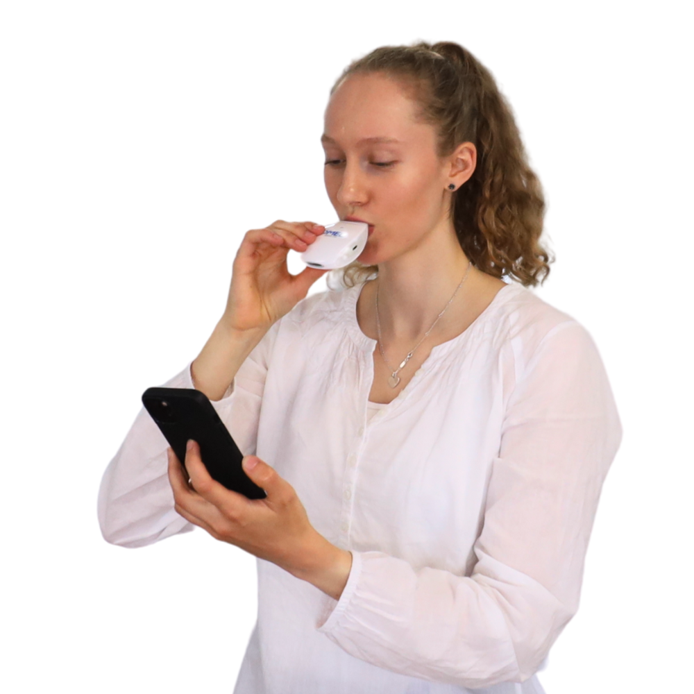 Woman with the OMED Health Breath Analyzer breath testing for gut health